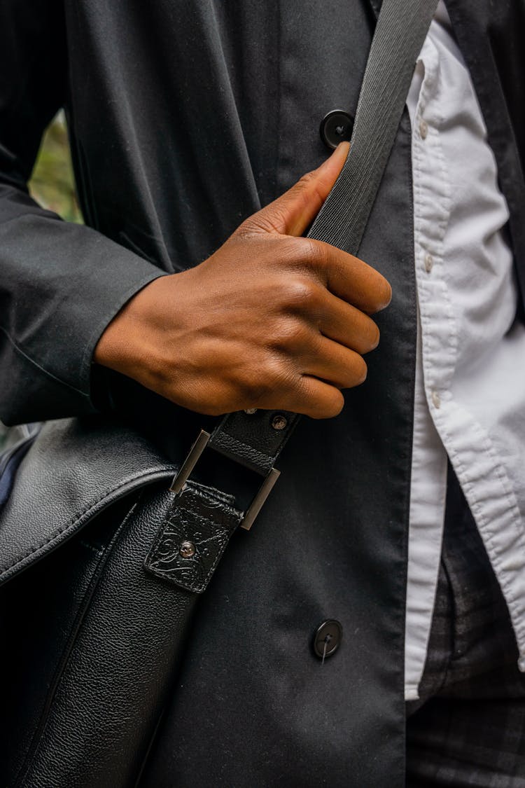 Photo Of A Person's Hand Holding The Strap Of A Bag