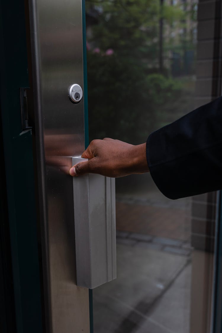 A Person Opening The Door