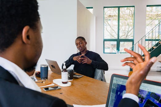 Professional business meeting with diverse team discussing strategies in a modern office setting.