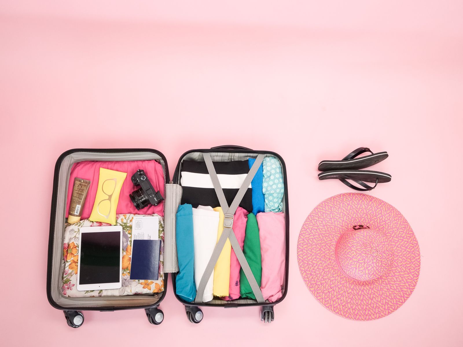 Open suitcase neatly arranged with travel essentials