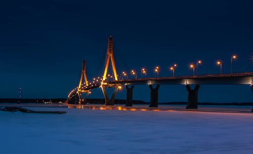 Lighted Bridge over Water during Night Time