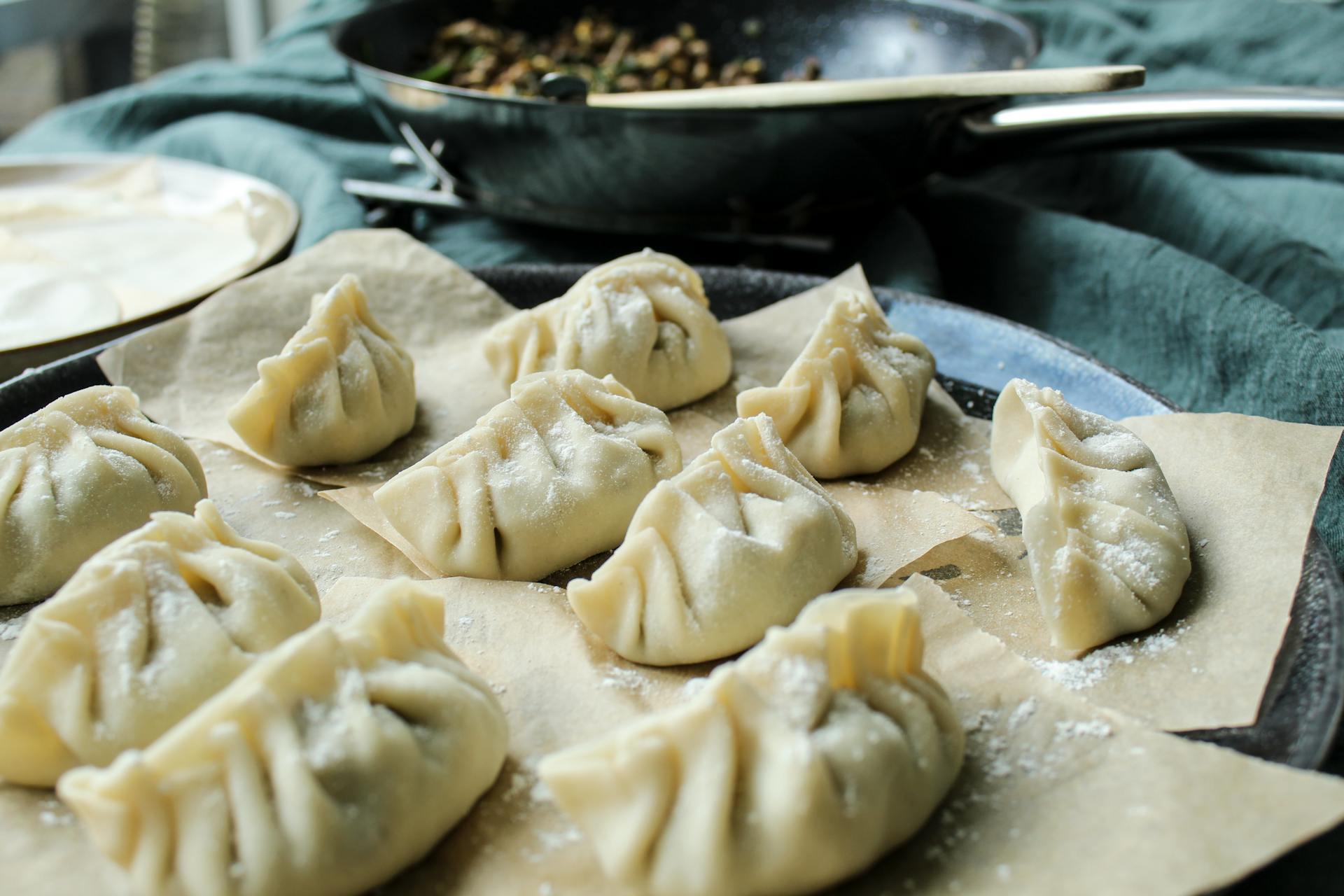 Freshly wrapped homemade dumplings ready to be cooked, showcasing Chinese cuisine at its finest.