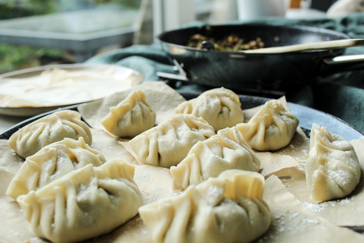 A close-up view of freshly made dumplings ready to be cooked, showcasing a delicious homemade touch.