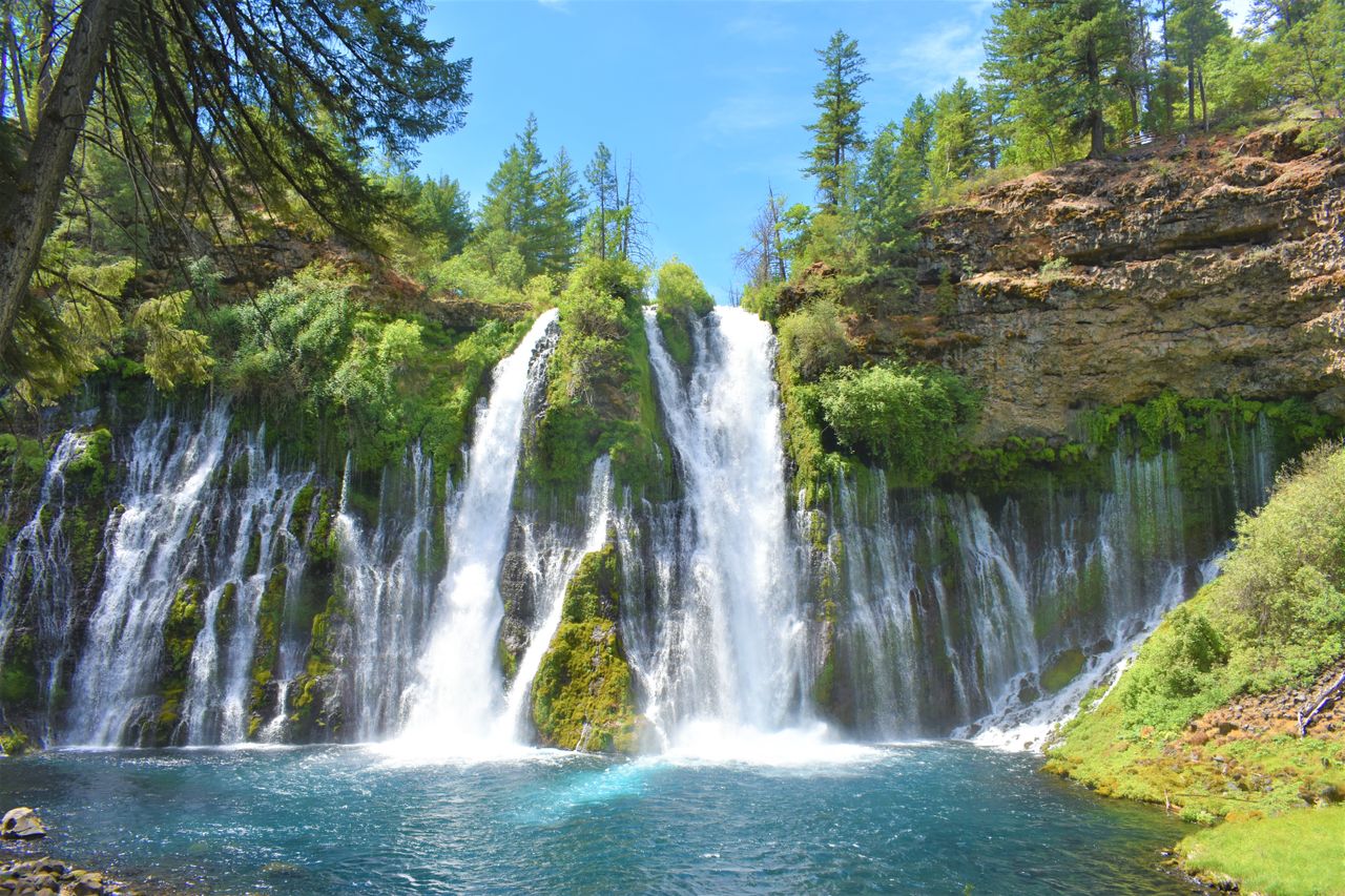 stunning waterfall amidst lush greenery on a bright day perfect for na
