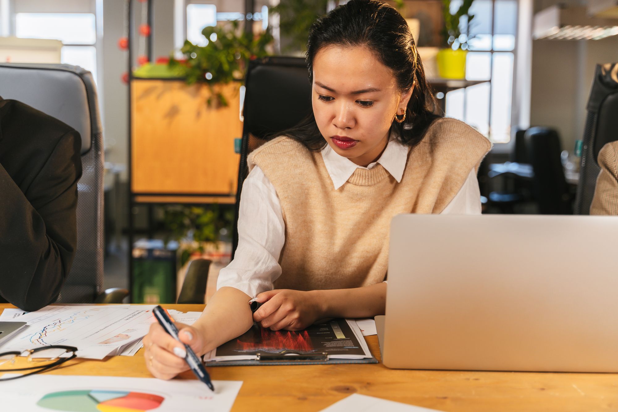 Professional reviewing charts and salary data on a laptop