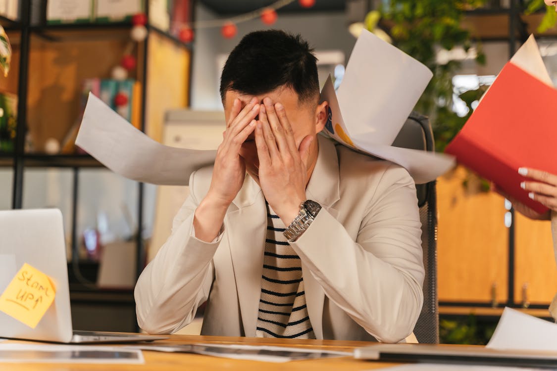 Man feeling burnout at work.