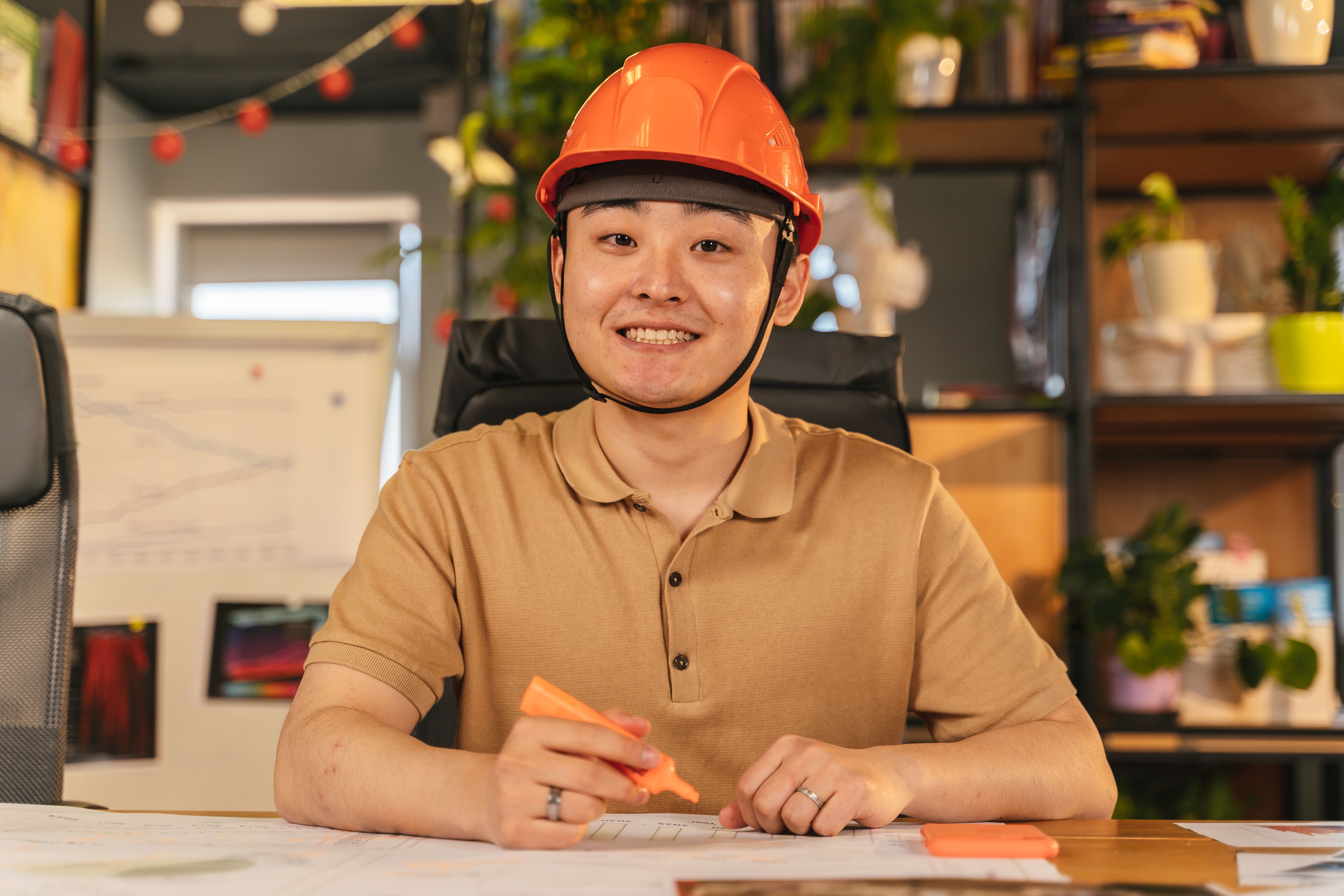 Engineer reviewing project documents at an office desk