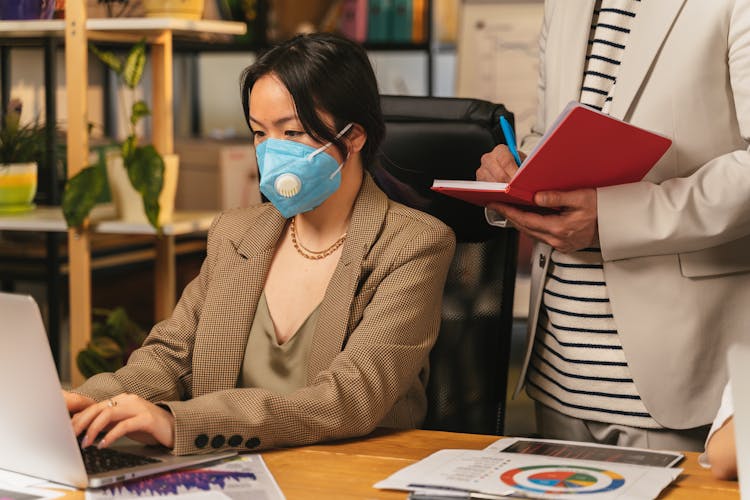 Woman Working On Laptop In Office