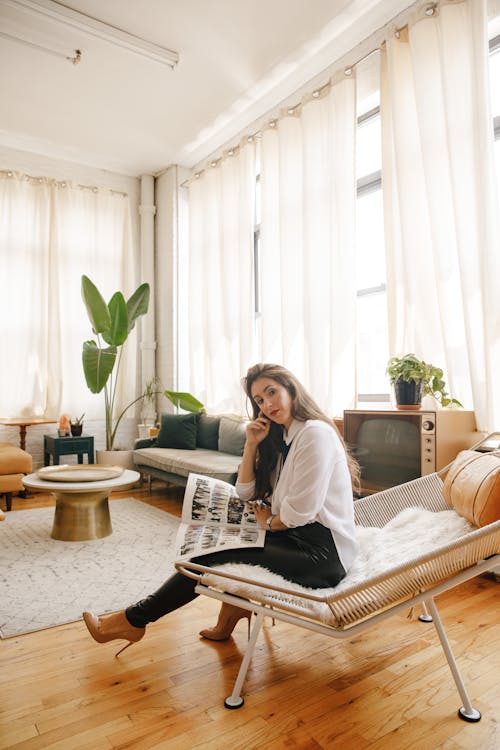 A Beautiful Woman in White Long Sleeves Sitting on the Chair