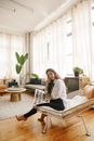Woman in White Long Sleeve Shirt Reading Newspaper