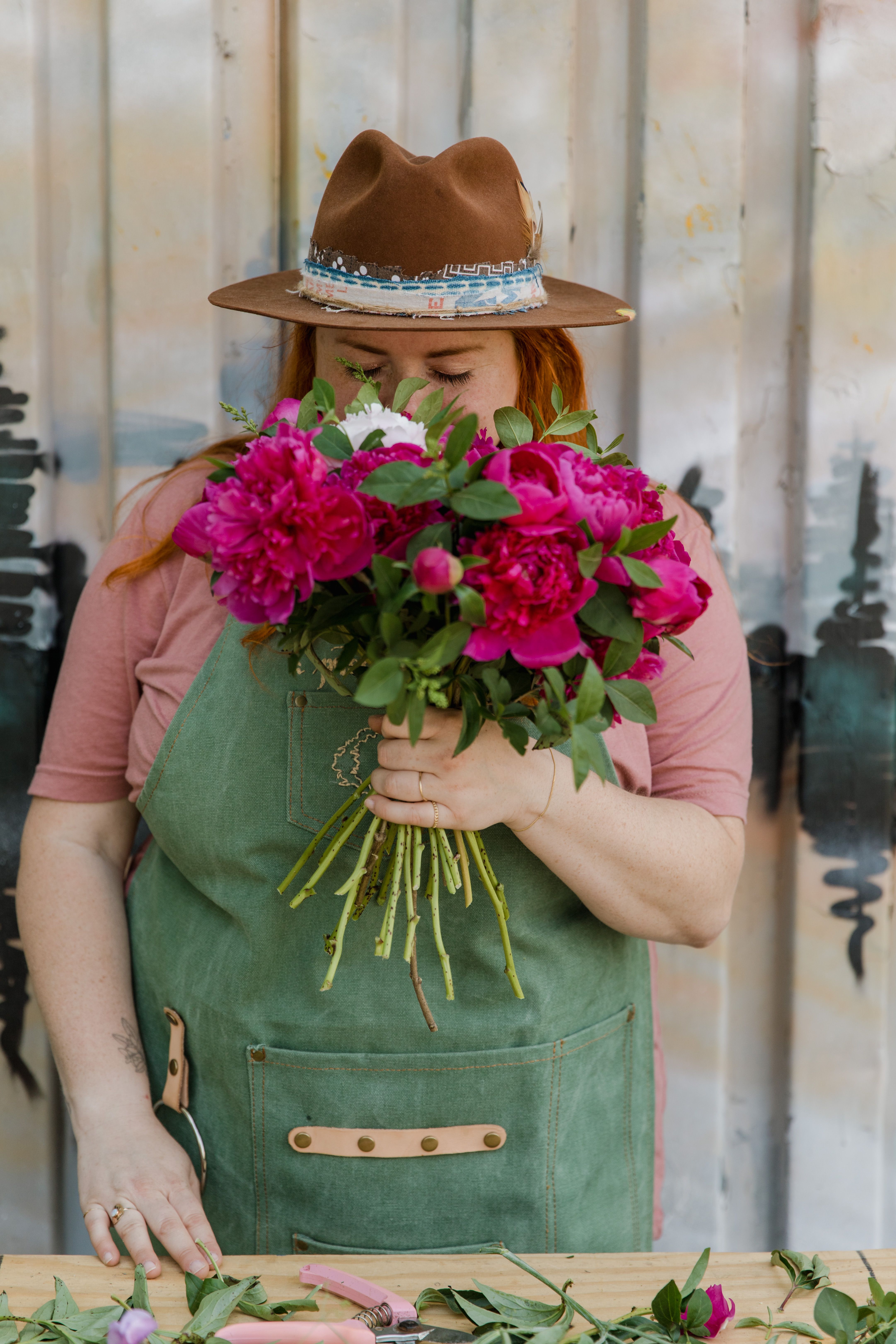 Woman in Pink Shirt Wearing Brown Hat Holding Pink Flowers · Free Stock ...