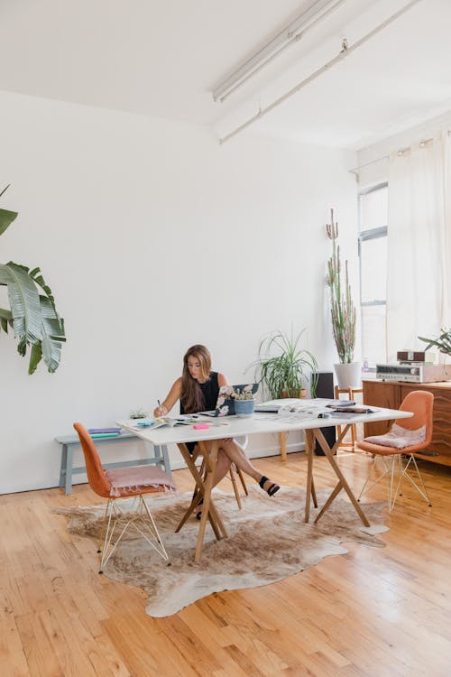 Woman in Black Shirt Sitting on Chair