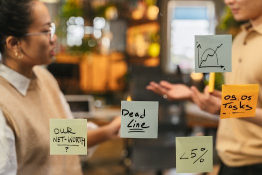 Office meeting with sticky notes on a glass wall showing discussions and brainstorming.