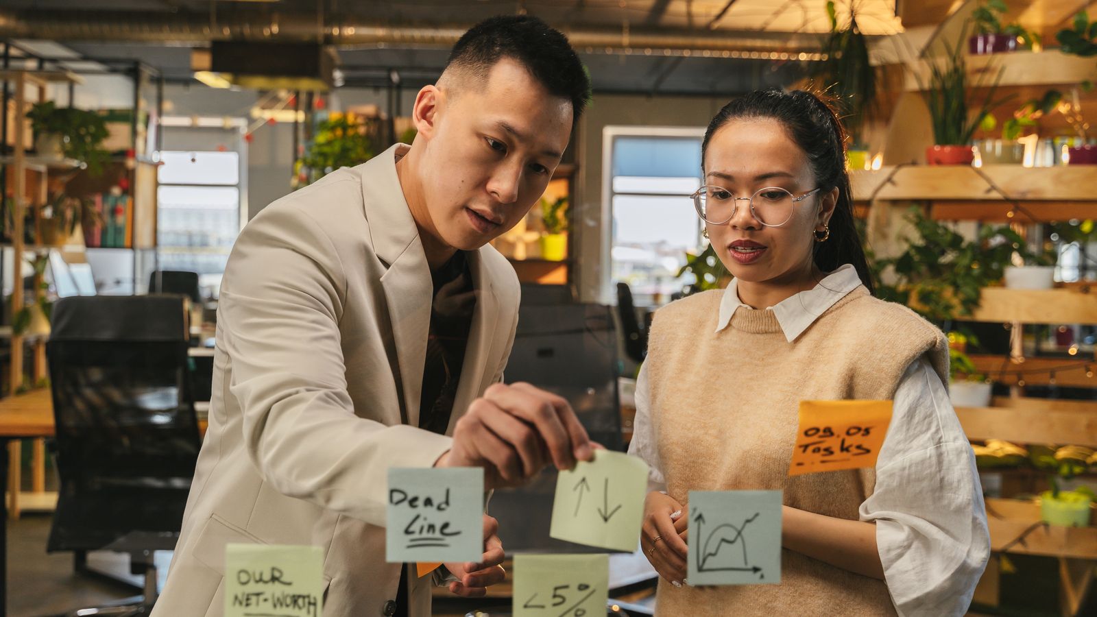 Two partners planning venture strategy with sticky notes