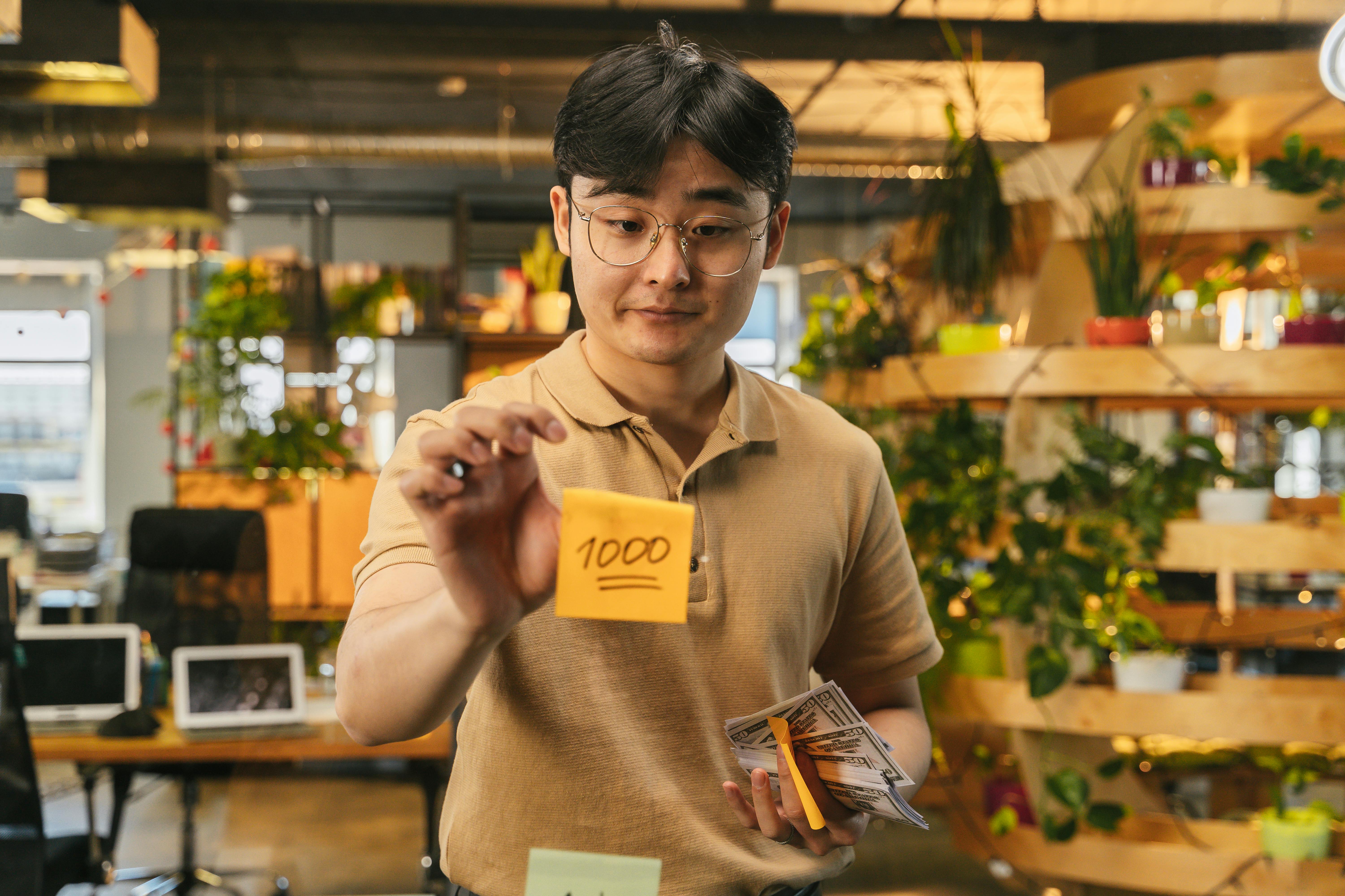 man with cash and sticky note