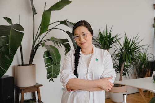 A Woman with Eyeglasses Posing with Her Arms Crossed