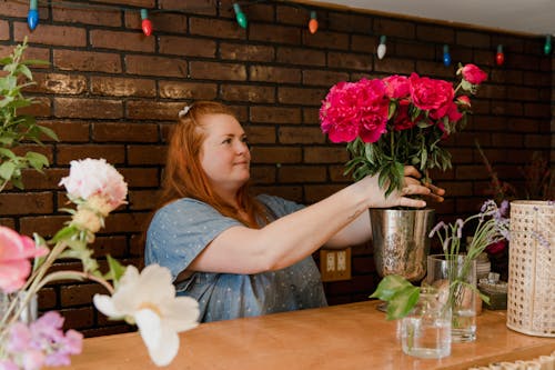 A Woman Holding Pink Flowers