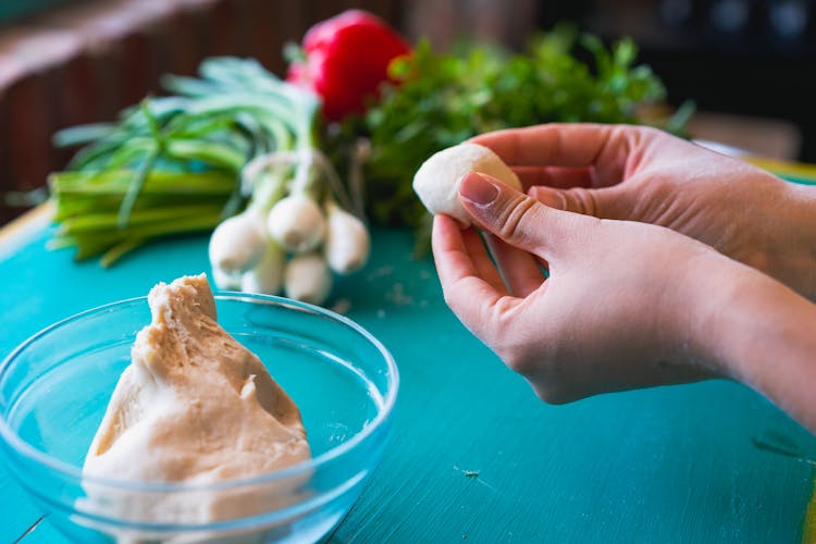 A Person Forming A Dough Ball