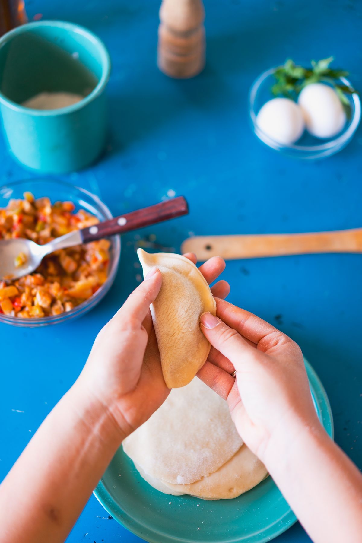 Person preparing vegetables and snacks on a cutting board