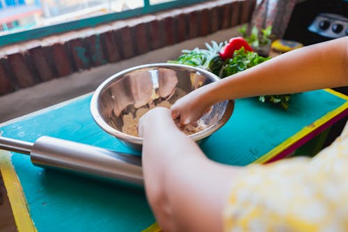 A Person Mixing Ingredients in a Bowl