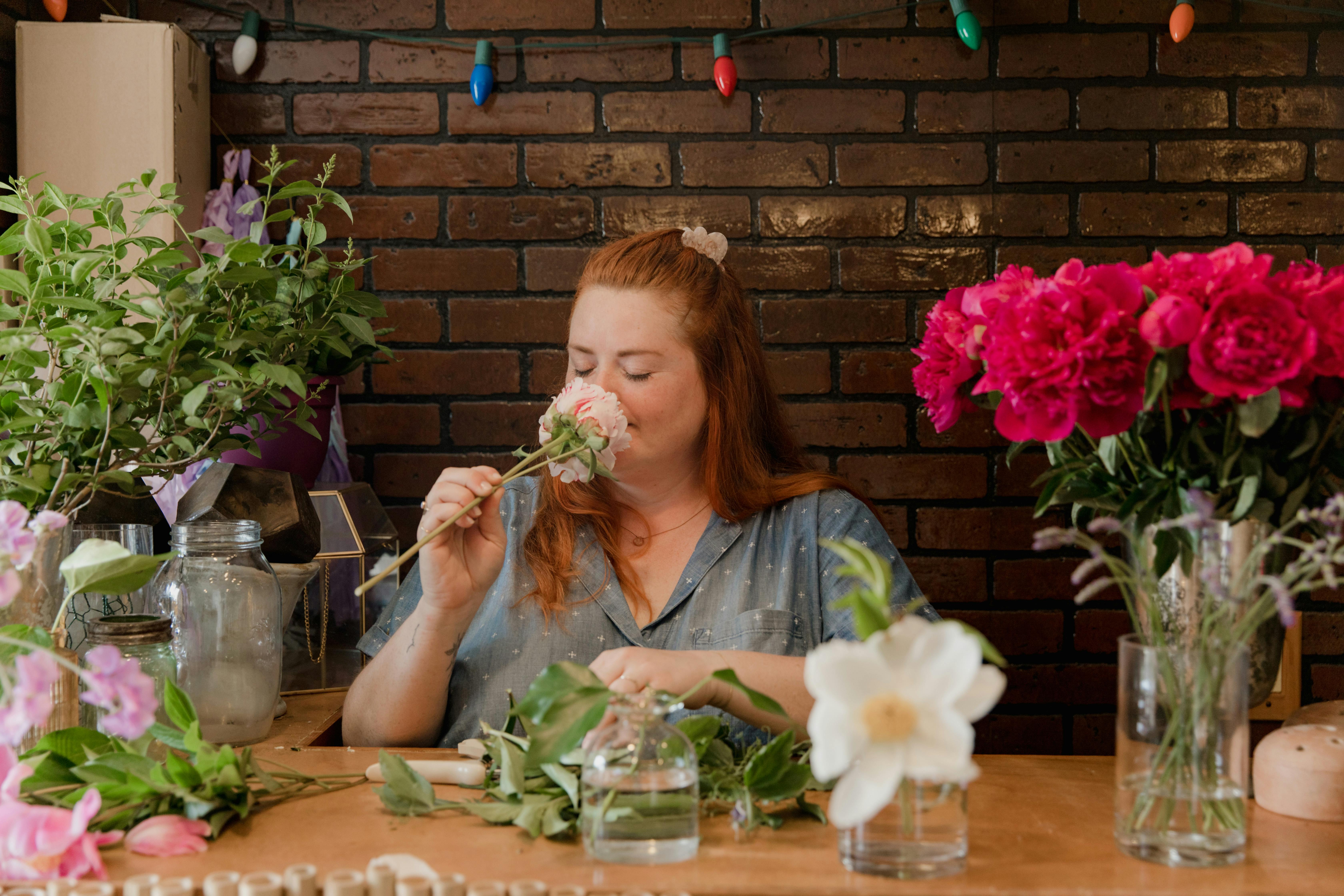 A woman working in a cozy flower shop, arranging beautiful floral bouquets.