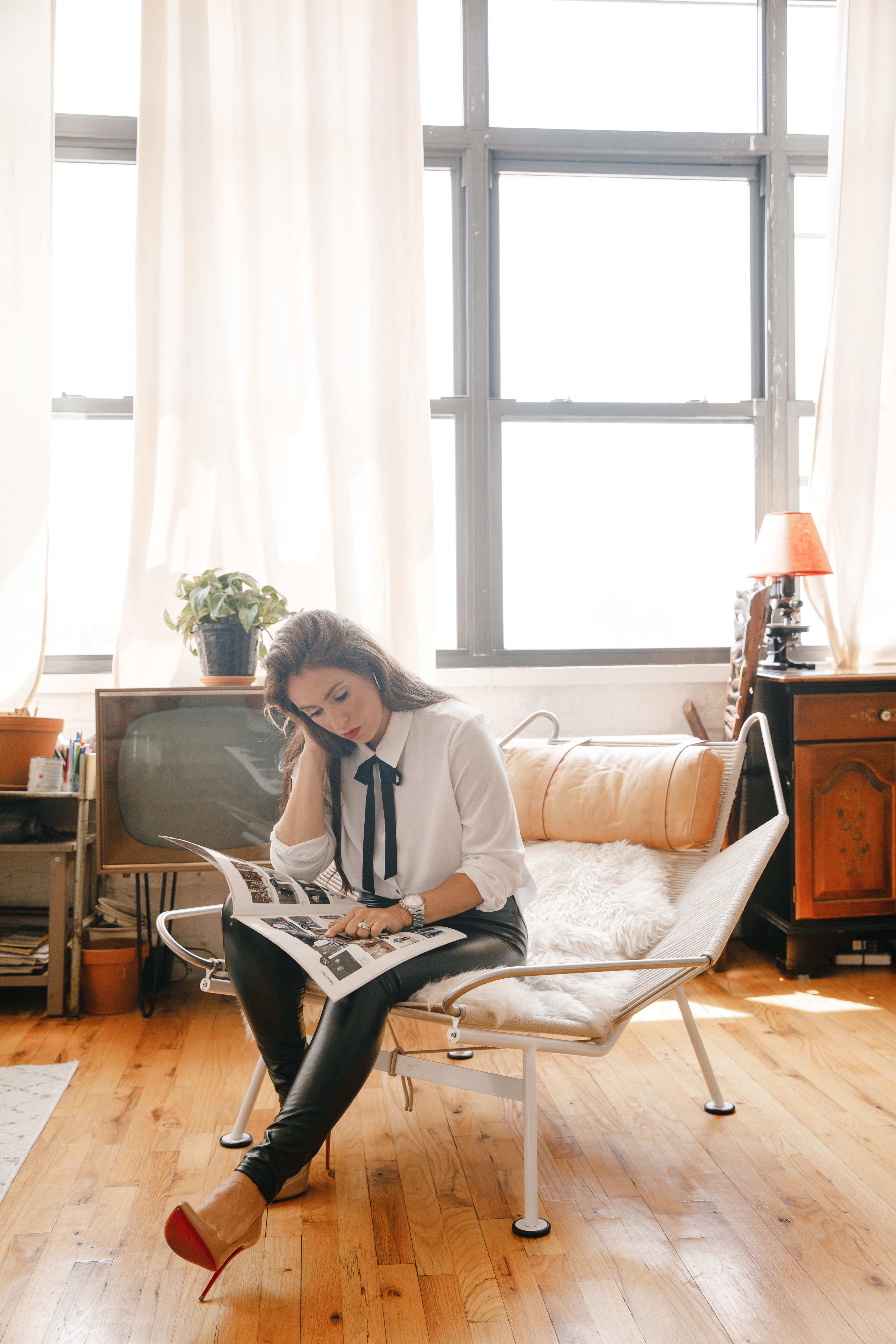 Woman in White Long Sleeve Shirt Sitting on White Couch · Free Stock Photo