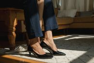 Woman in Blue Denim Jeans and Black Leather Flats