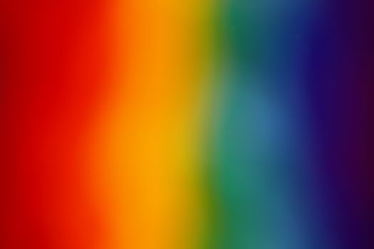 A colorful abstract gradient background featuring a vibrant rainbow spectrum.