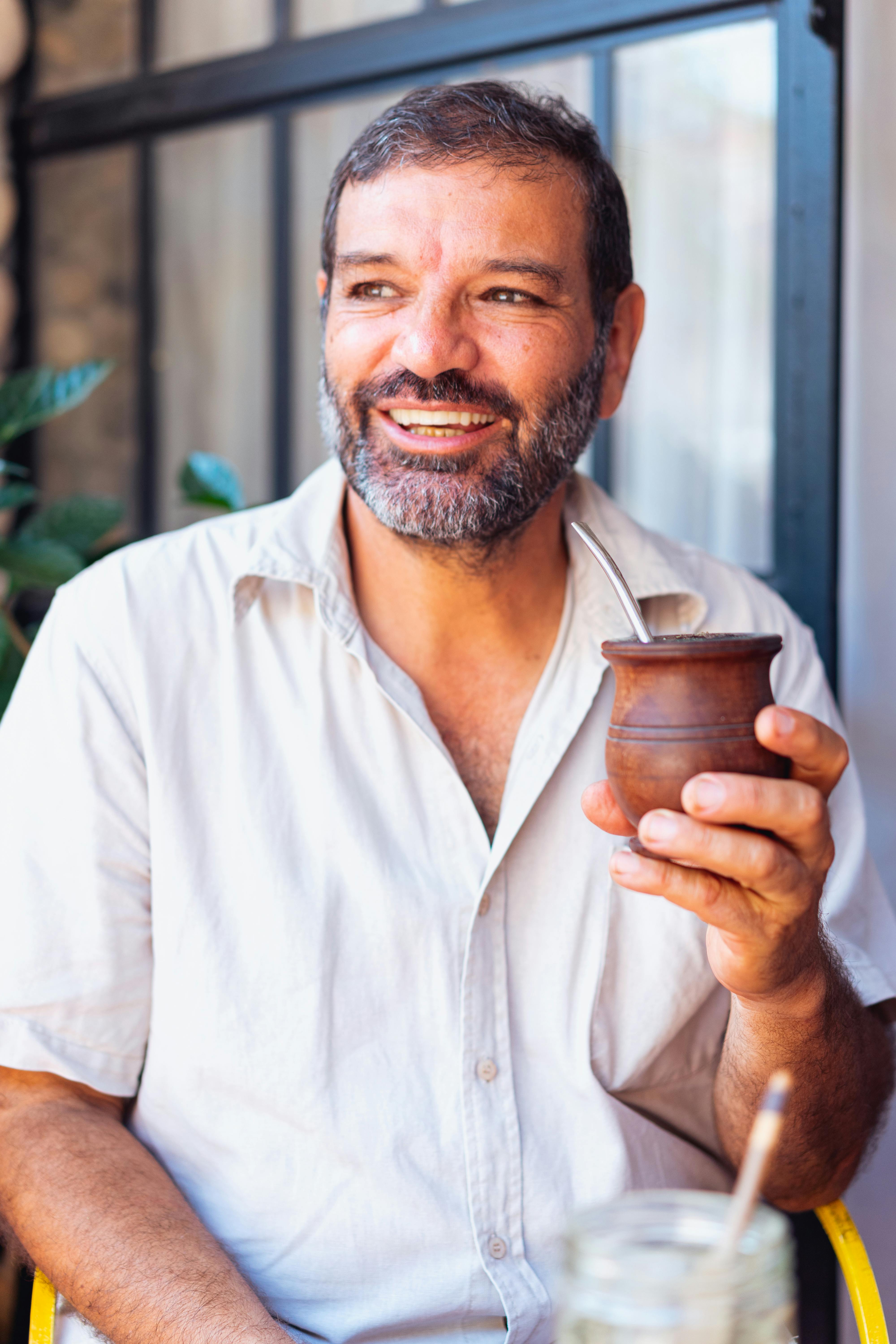 a man holding a wooden cup