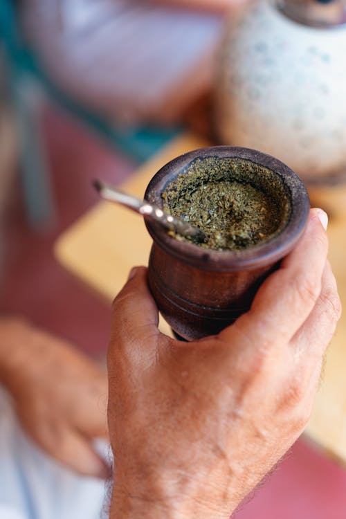 A Person Holding a Wooden Cup