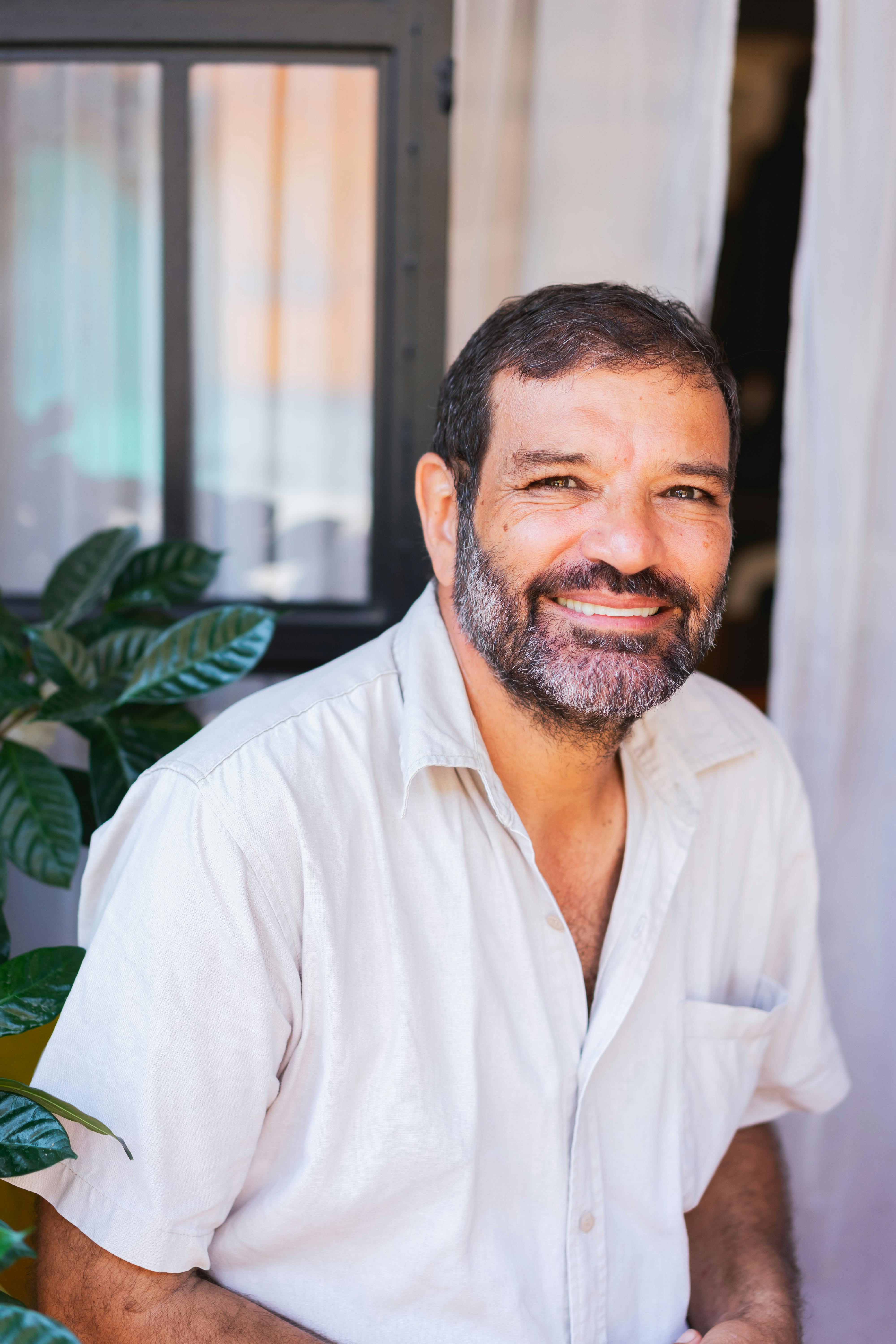 a man in white button up shirt smiling