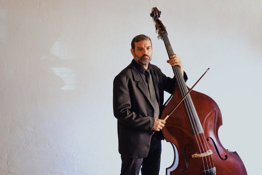 A Bearded Man Playing the Cello