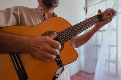 Free Close-Up Shot of a Person Playing an Acoustic Guitar Stock Photo