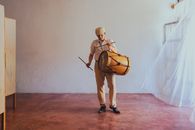 Man Playing Violin on Red Carpet