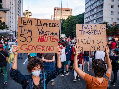 Free Protesters hold signs criticizing government during a rally in São Paulo, Brazil, advocating for human rights and democracy. Stock Photo