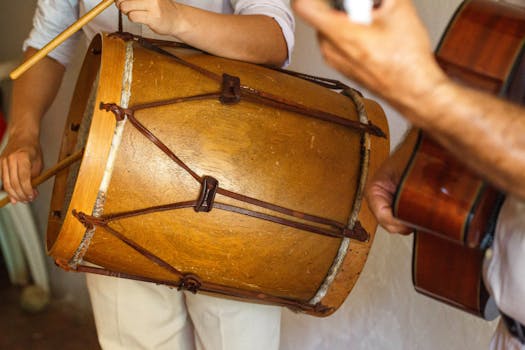 Musicians performing with a bombo drum and guitar, capturing the essence of traditional music.