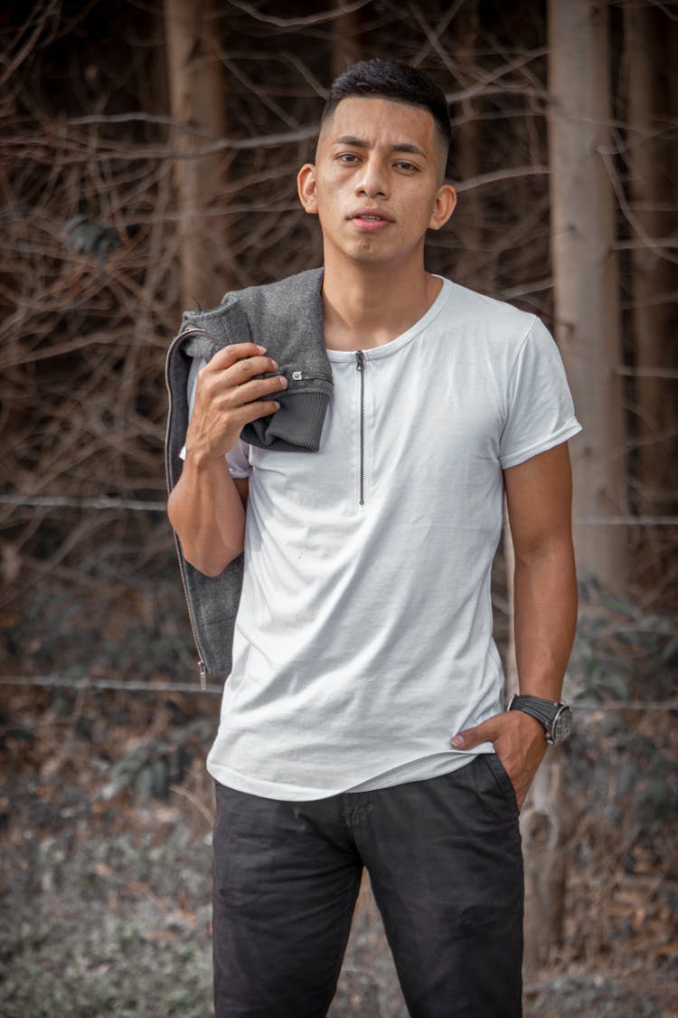 Man In White Shirt Holding His Jacket Over Shoulder