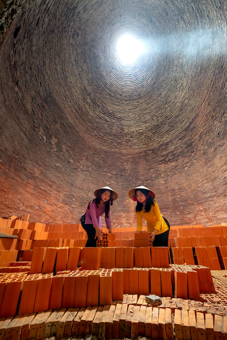 Women Wearing Rice Hat Stacking The Bricks