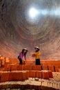 Busy Women in Rice Hat Carrying Red Bricks