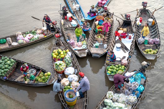 Colorful floating market showcasing boats with fruits and vegetables being sold by merchants.