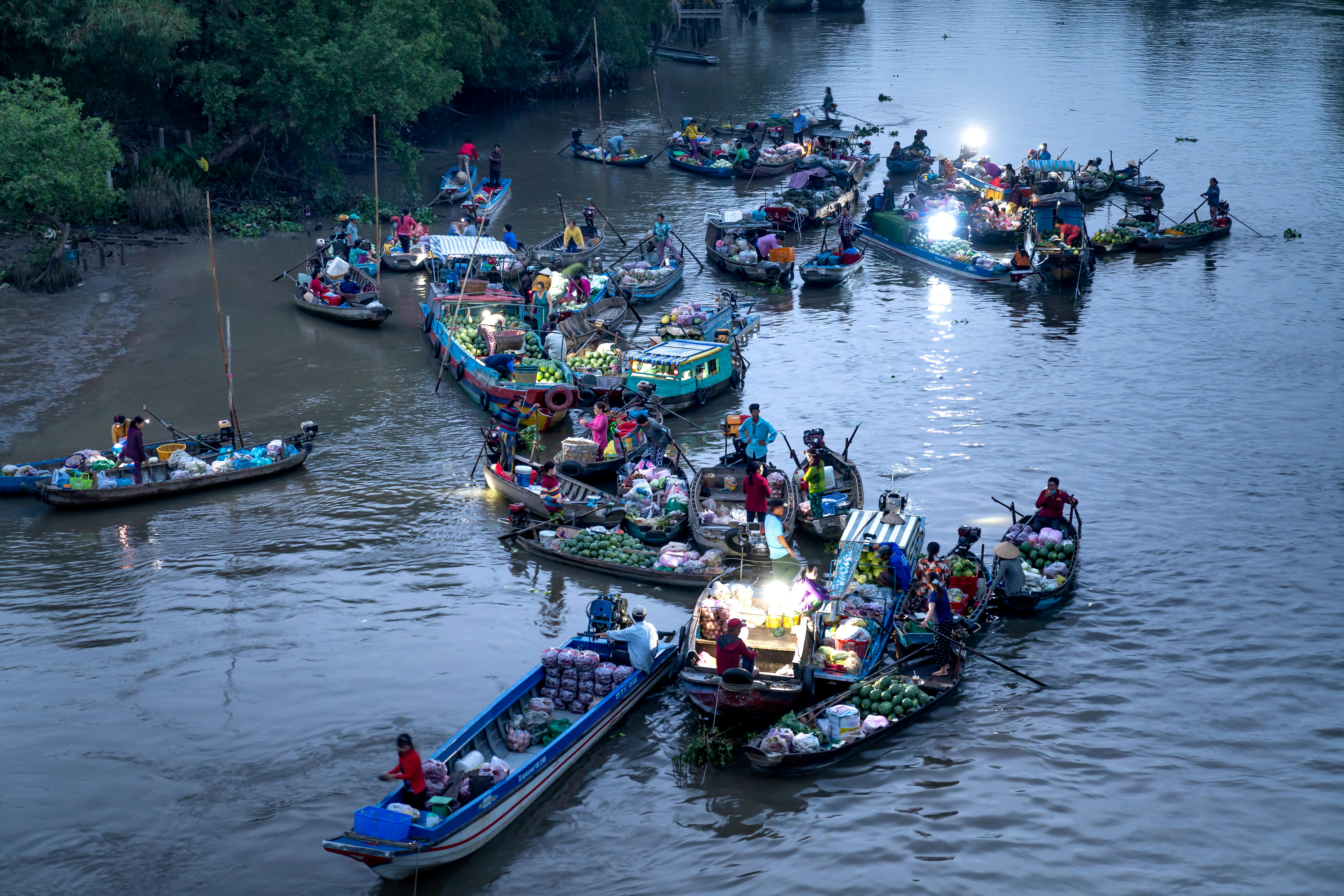 Free Vibrant floating market scene with numerous boats on a river in Vietnam. Stock Photo