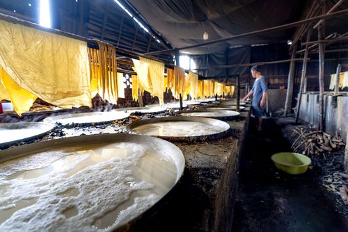Free A glimpse of traditional rice paper production inside a Vietnamese workshop. Stock Photo