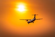 White and Red Airplane Flying during Sunset
