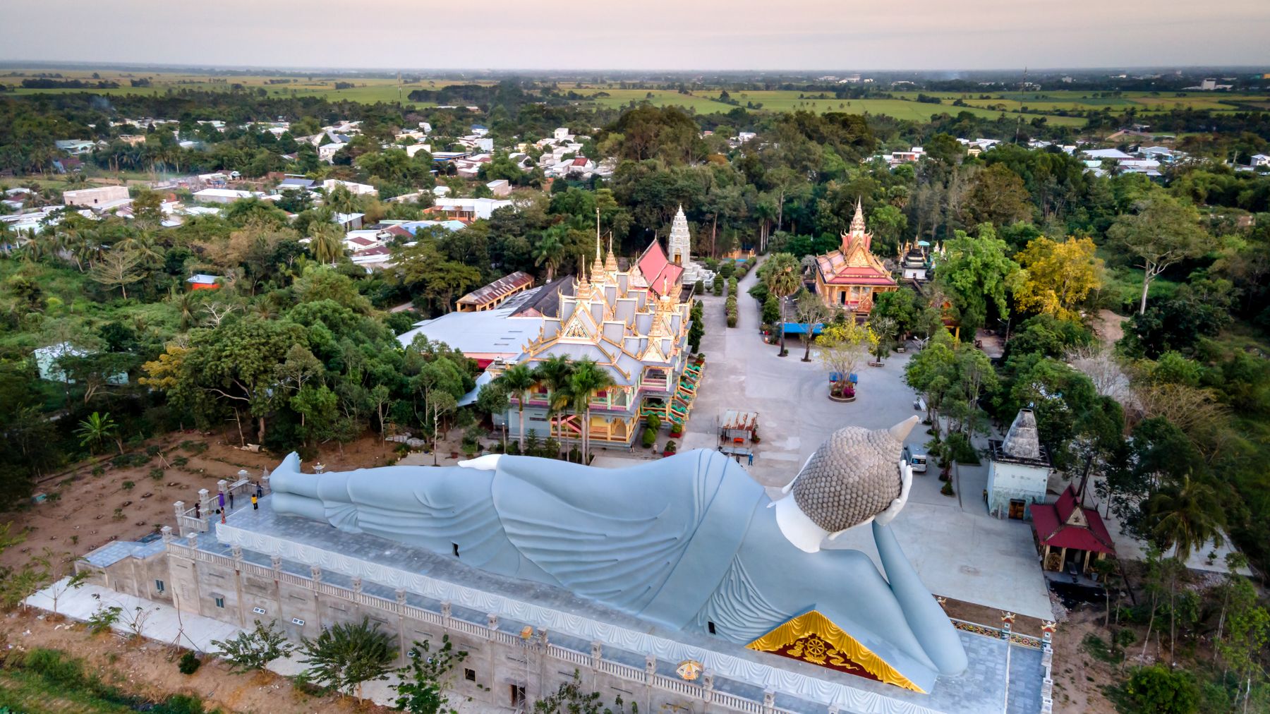A stunning aerial shot of the Reclining Buddha statue and surrounding architecture in Soc Trang, Vietnam.