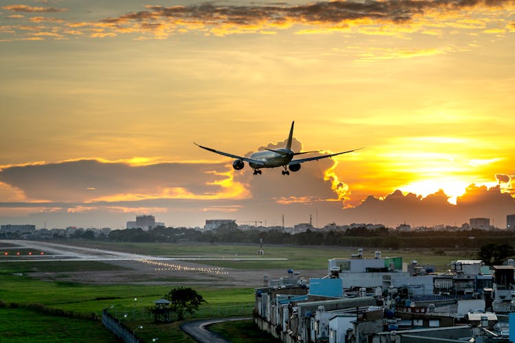 An Airplane About To Take Off During Sunset