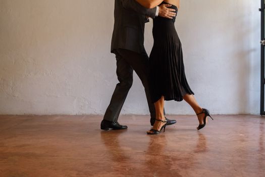 Two People Dancing Tango on Concrete Floor