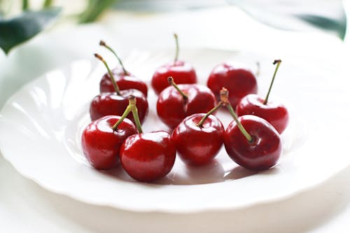 Red Cherries on White Ceramic Plate