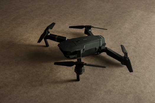 Detailed photo of a black drone toy on a textured surface, showcasing modern design.