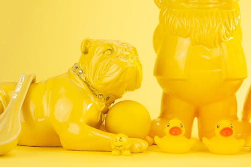 Figurines on Yellow Surface