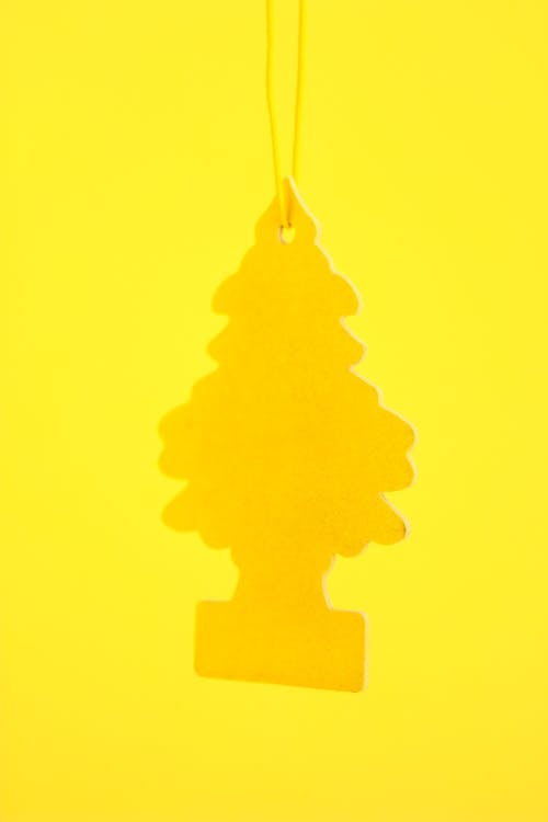 Close-up of a Yellow Wunderbaum Car Fragrance 